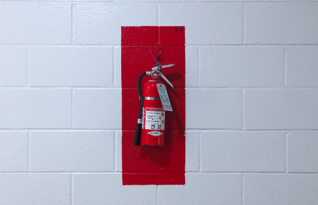 a fire extinguisher hanging on a wall