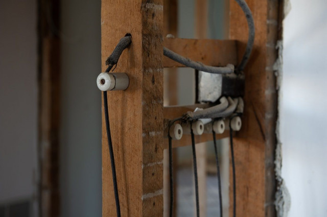 knob and tube wiring in wooden frames of a home