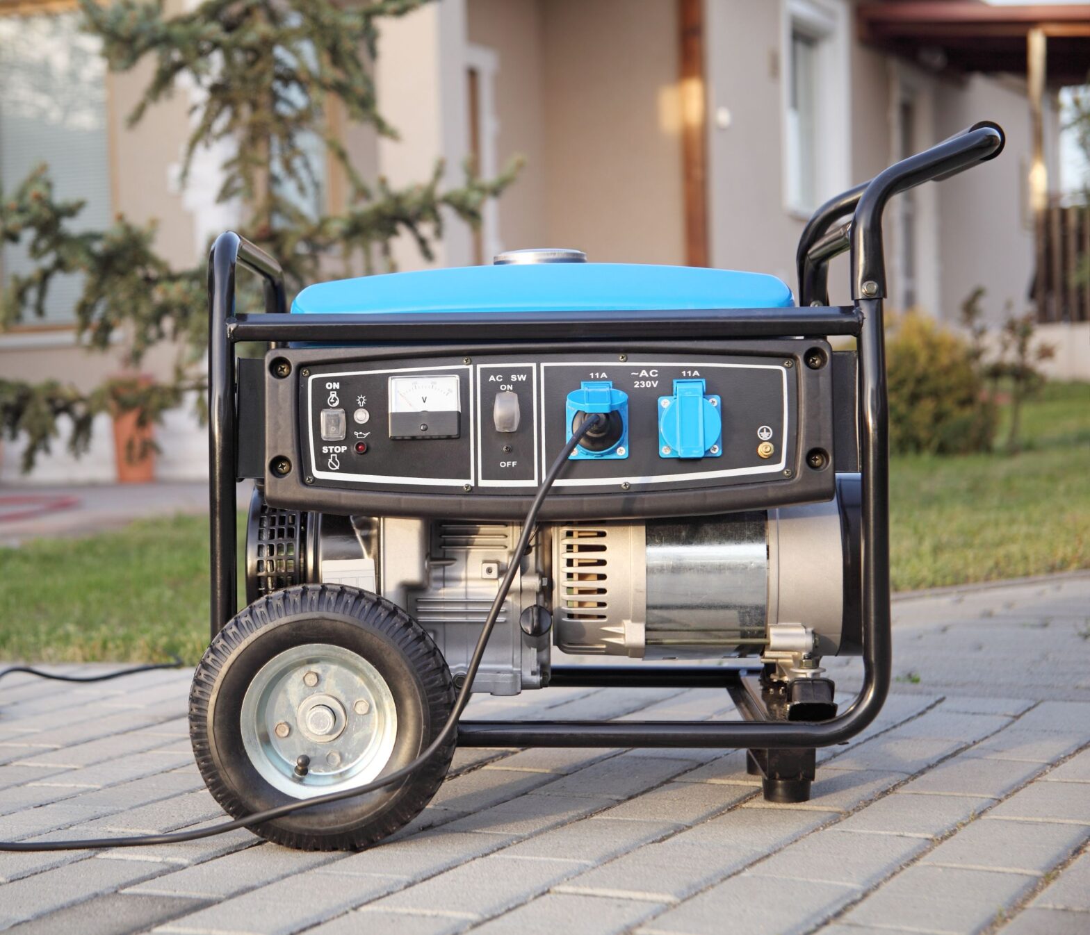 a blue generator on a driveway