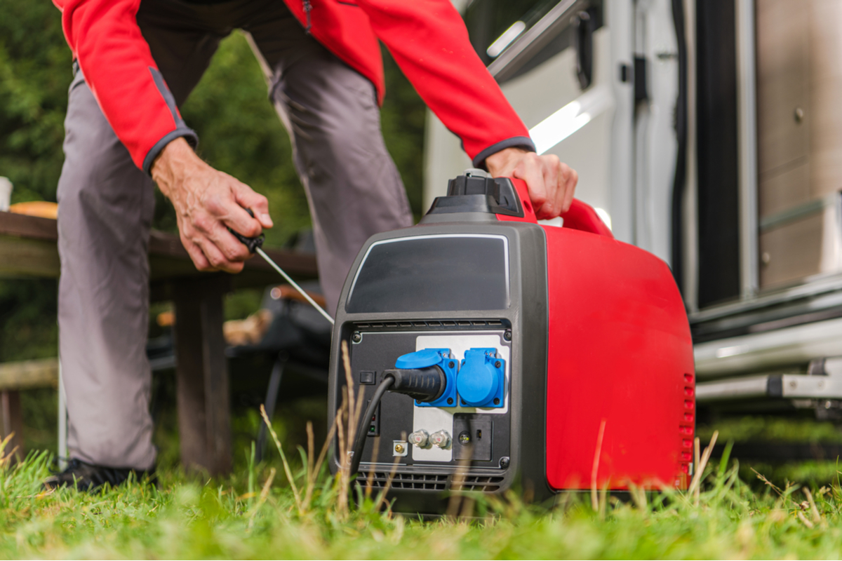 a homeowner pulling a cord on a portable generator