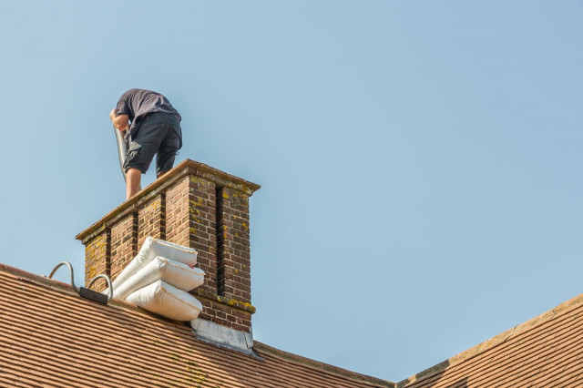 a professional installing a new chimney liner