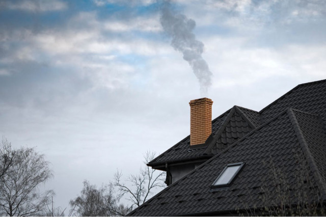 a chimney with smoke billowing out of the top