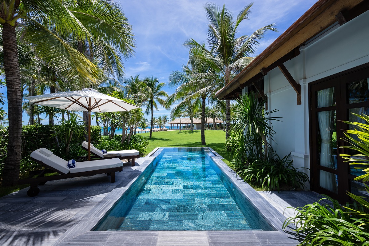 small outdoor pool behind a bungalow