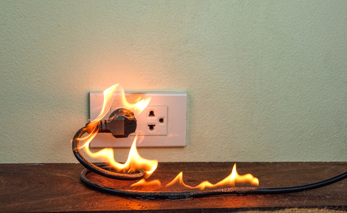 an outlet and plug on fire