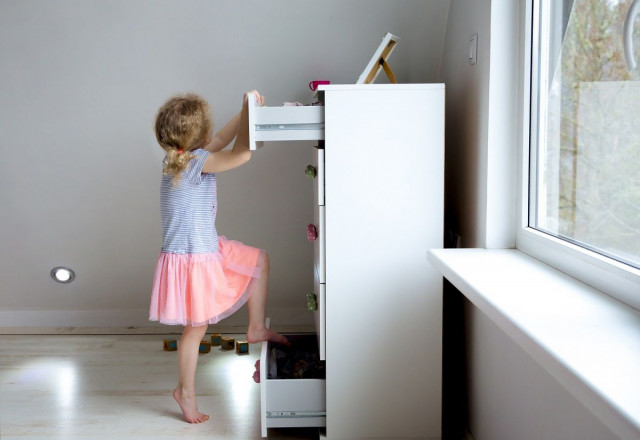 child climbing on furniture