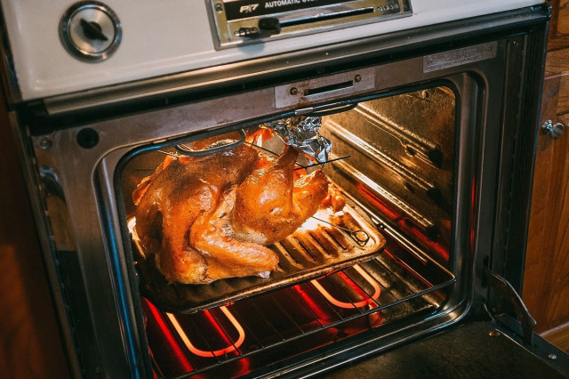 a turkey roasting inside an oven