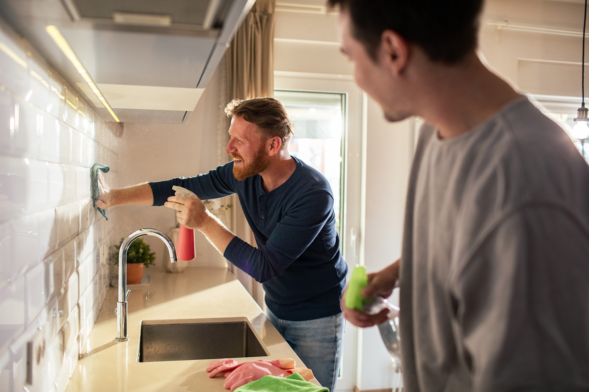 Couple cleaning modern kitchen at home