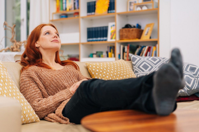 reclining person with feet up on coffee table