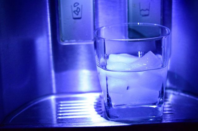 glass of ice water in a refrigerator dispenser