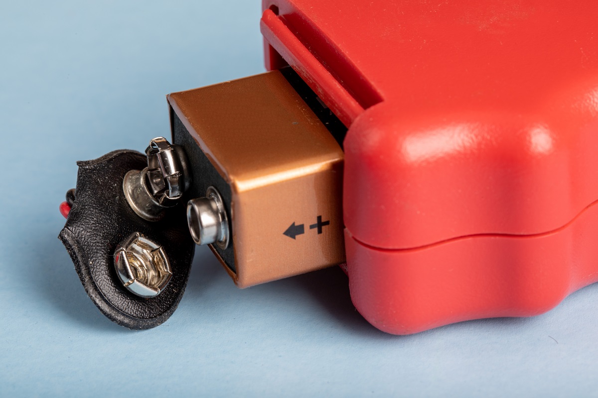 a 9-volt battery popping out of a handheld device