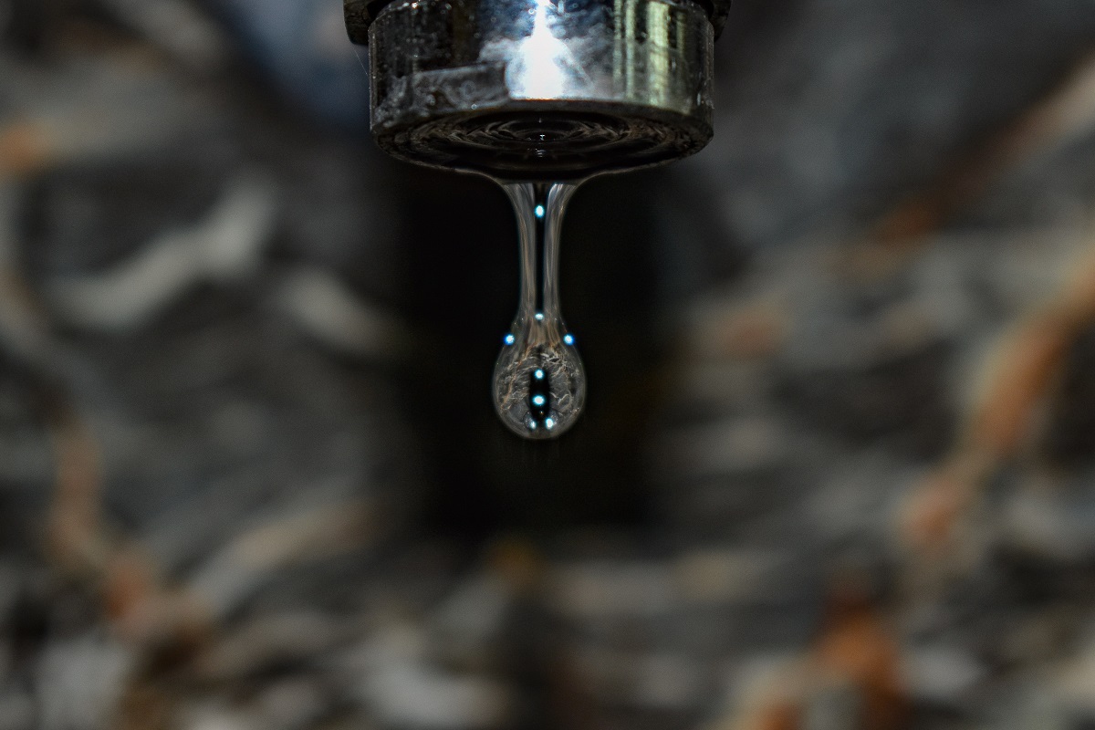 a droplet of water falling from a faucet