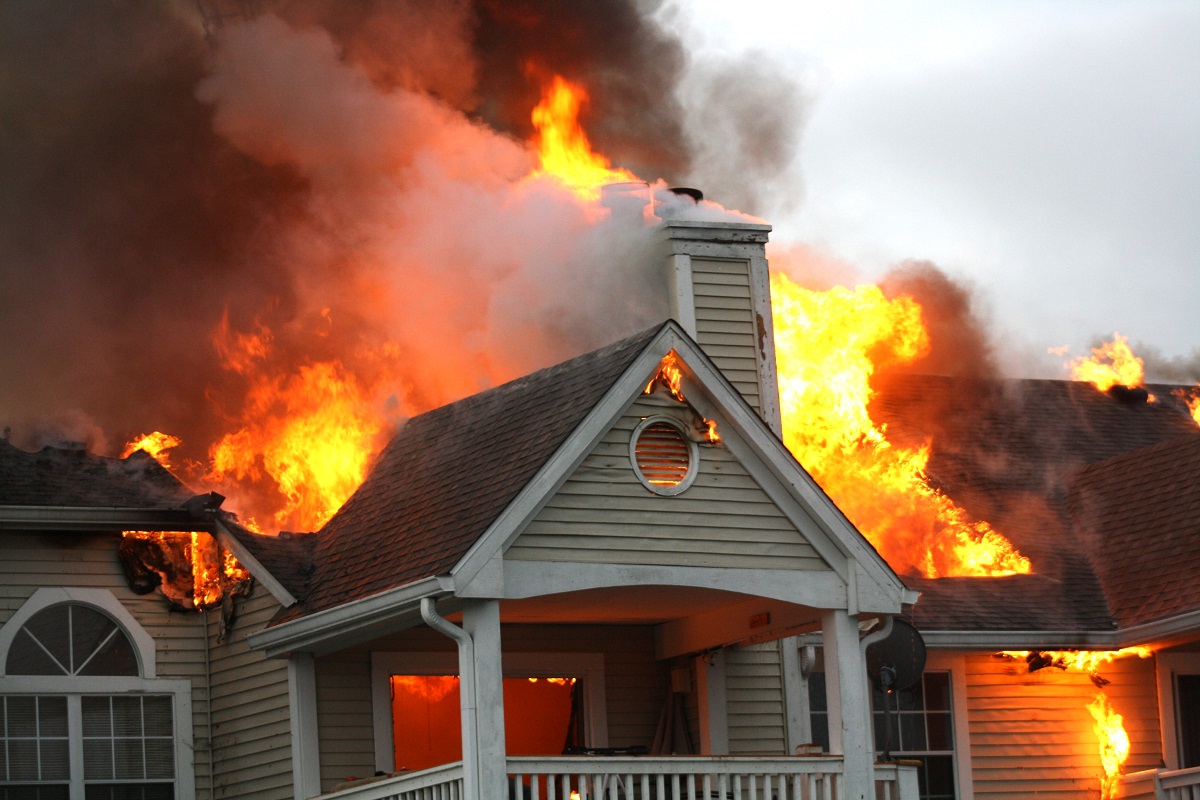a home with flames coming out the roof