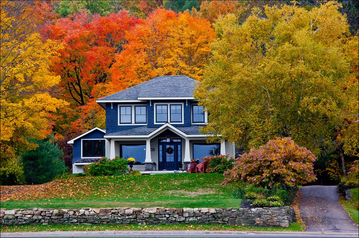 a fall home with colored trees around it