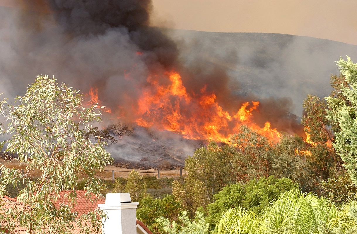 a wildfire burning on the side of a mountain