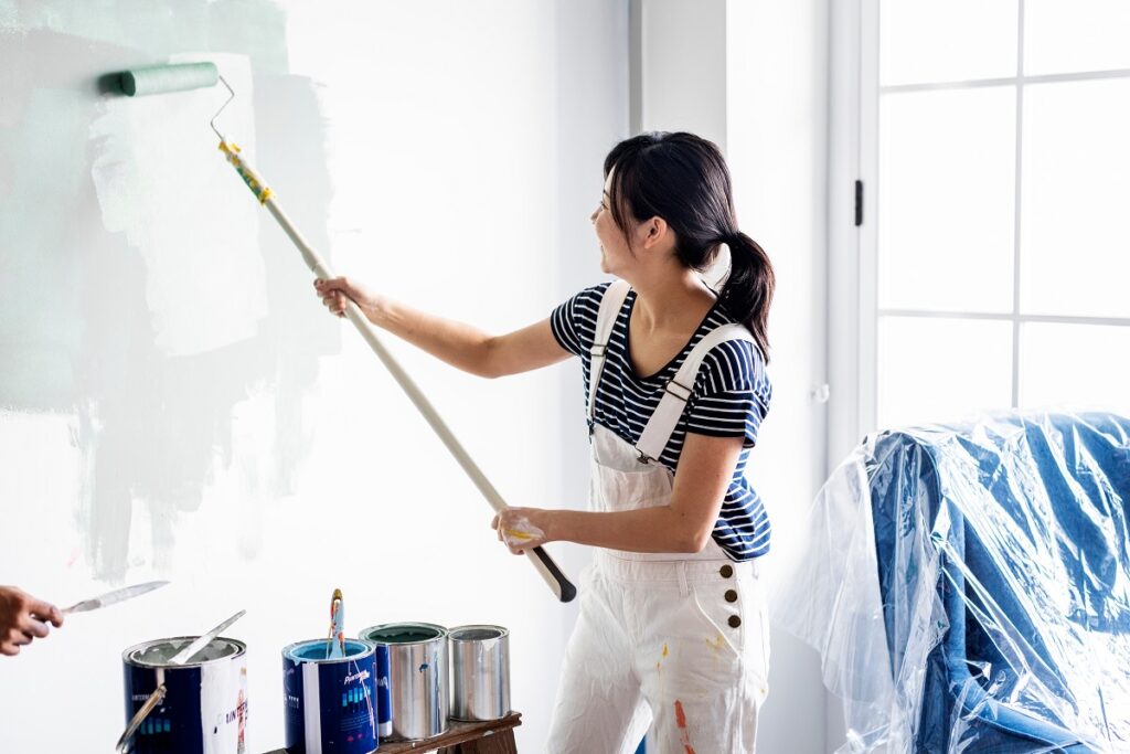 woman using a paint roller
