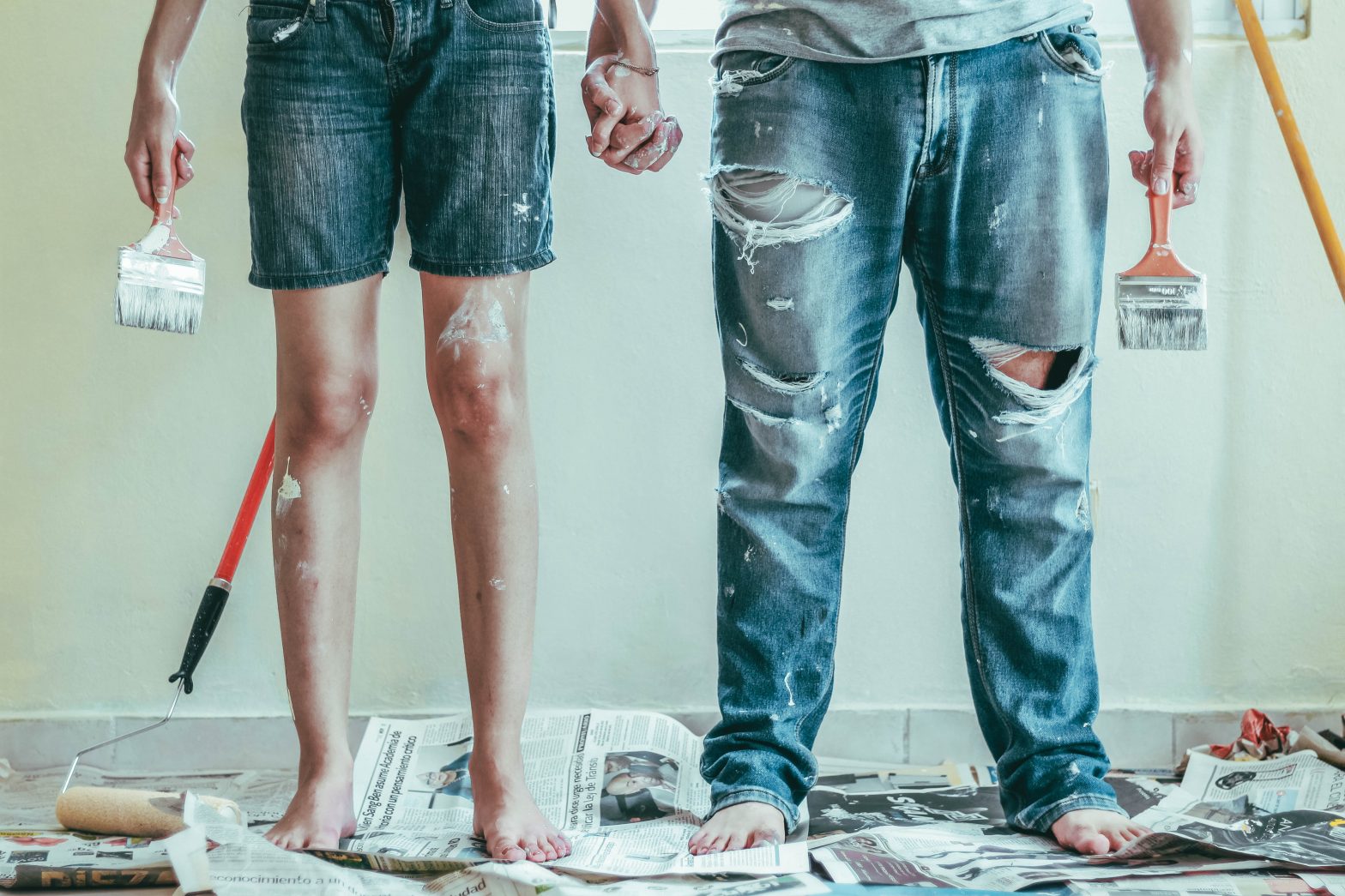 a couple holding hands after painting