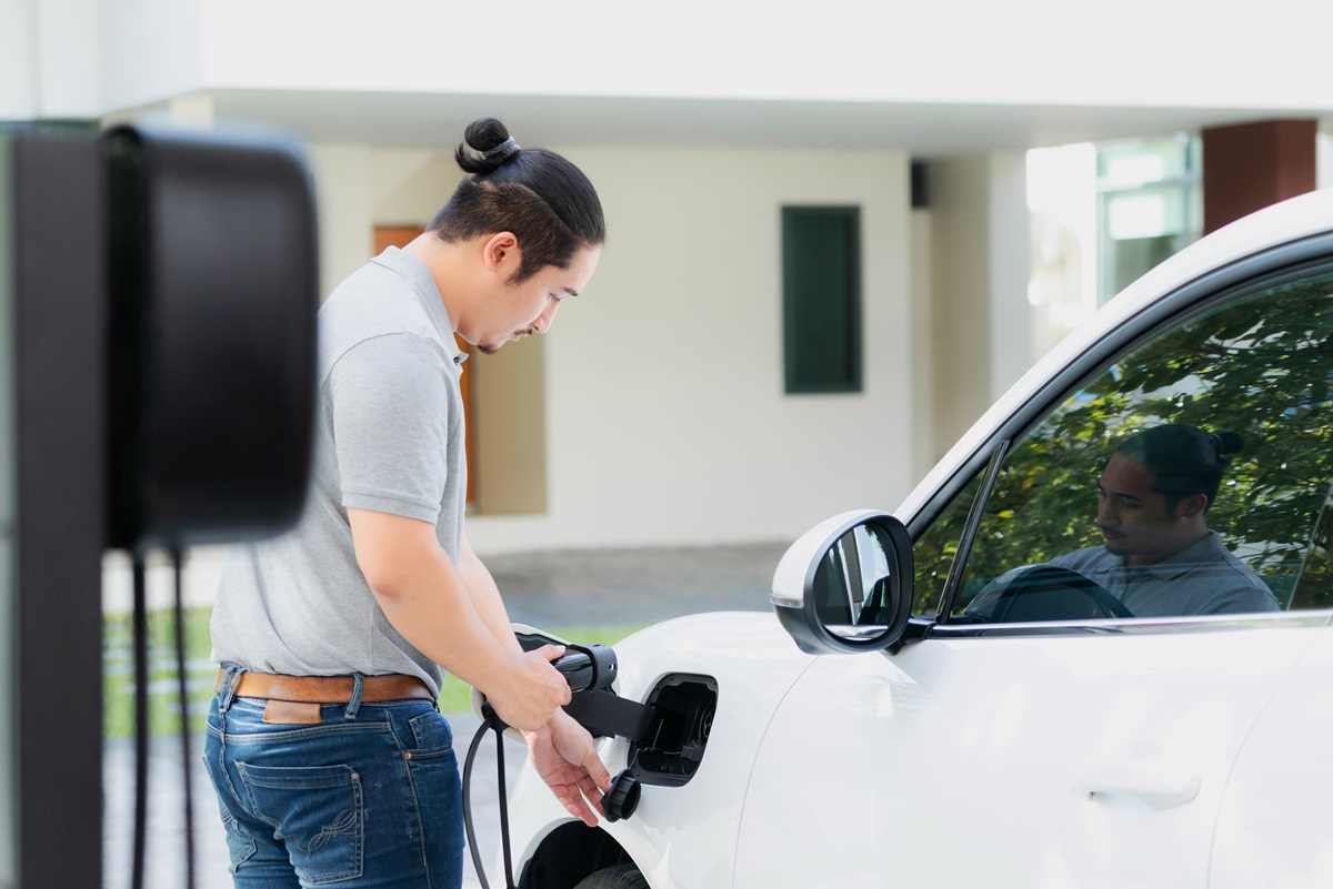 a person plugging in their EV at home
