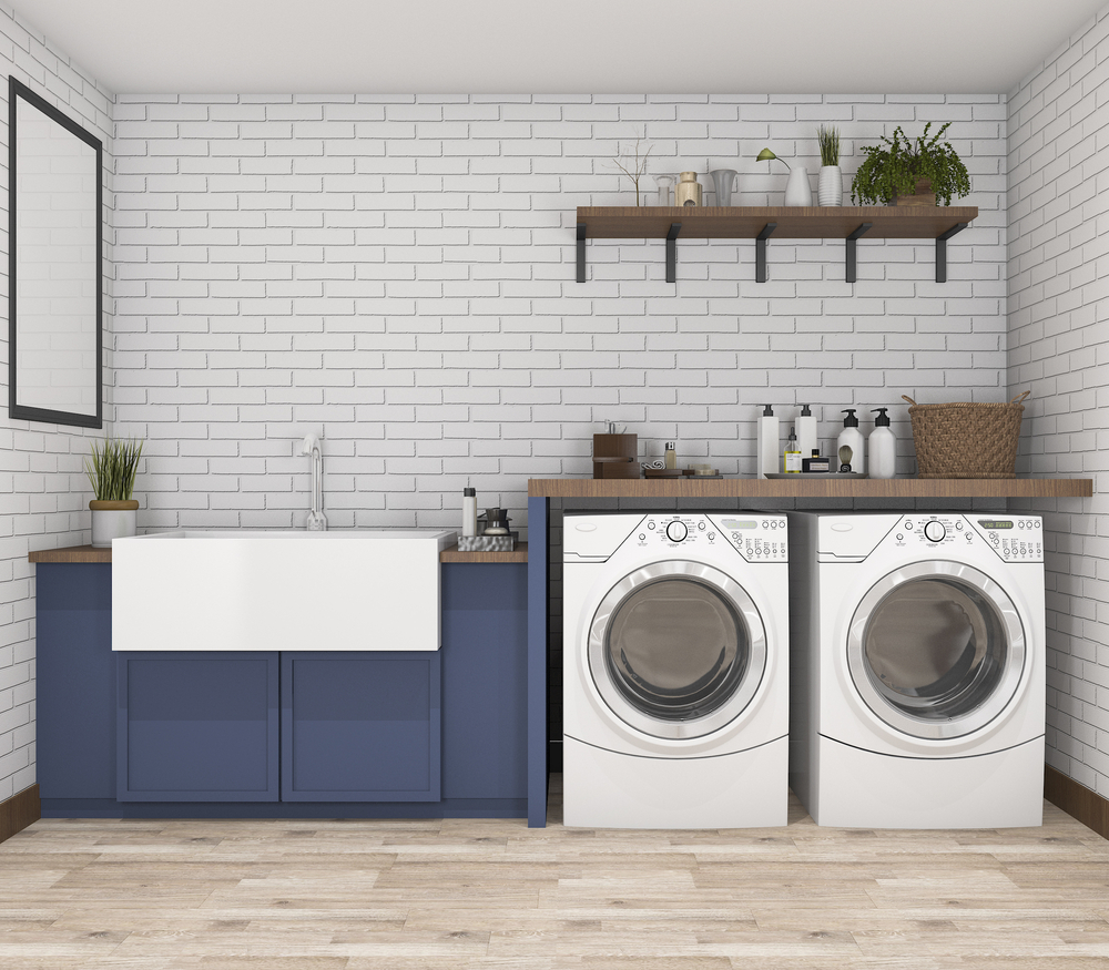 a laundry room with two white appliances and a blue cabinet