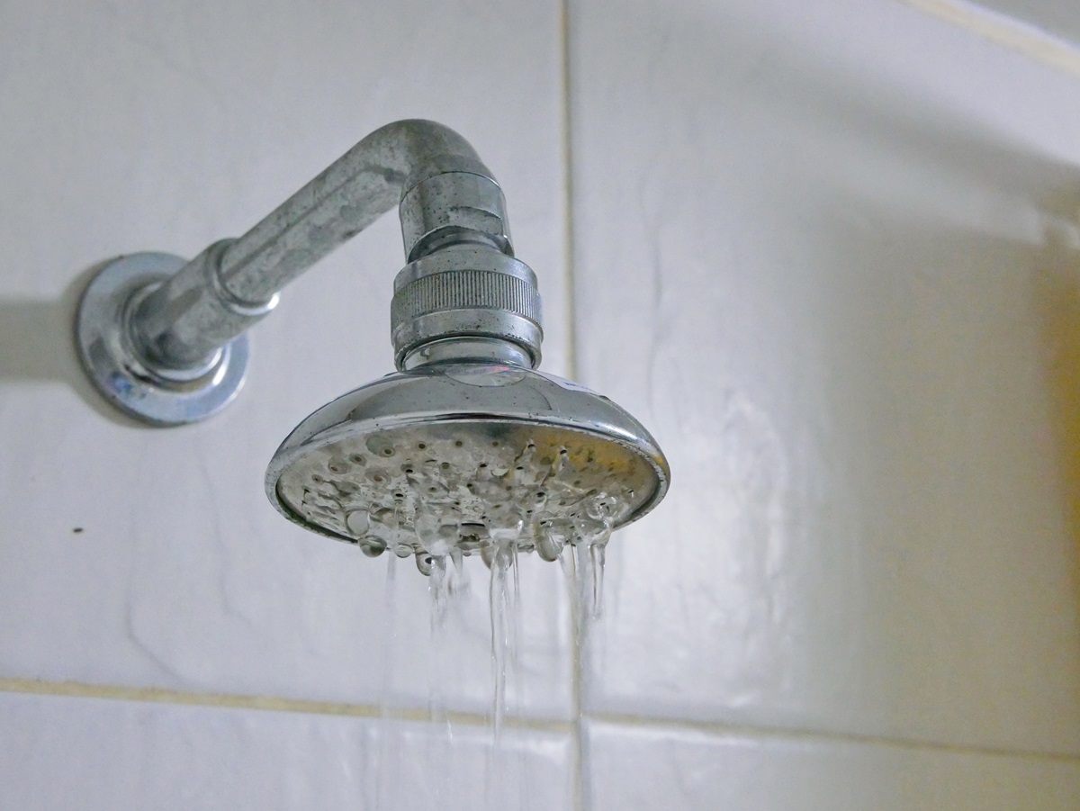 Close up of shower head in a bathroom with low pressure