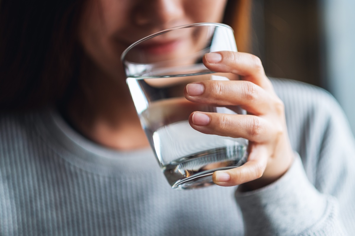 a woman drinking a glass of water
