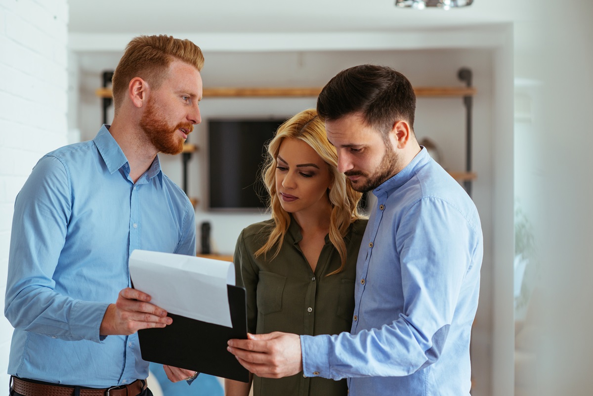 home buyers looking over an inspector's clipboard