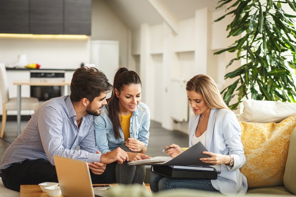 a couple meeting their financial advisor in a living room
