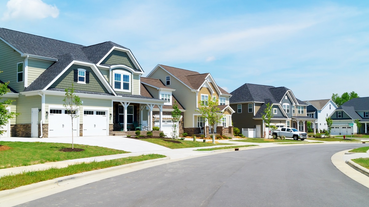 a neighborhood street lined with upper middle class homes