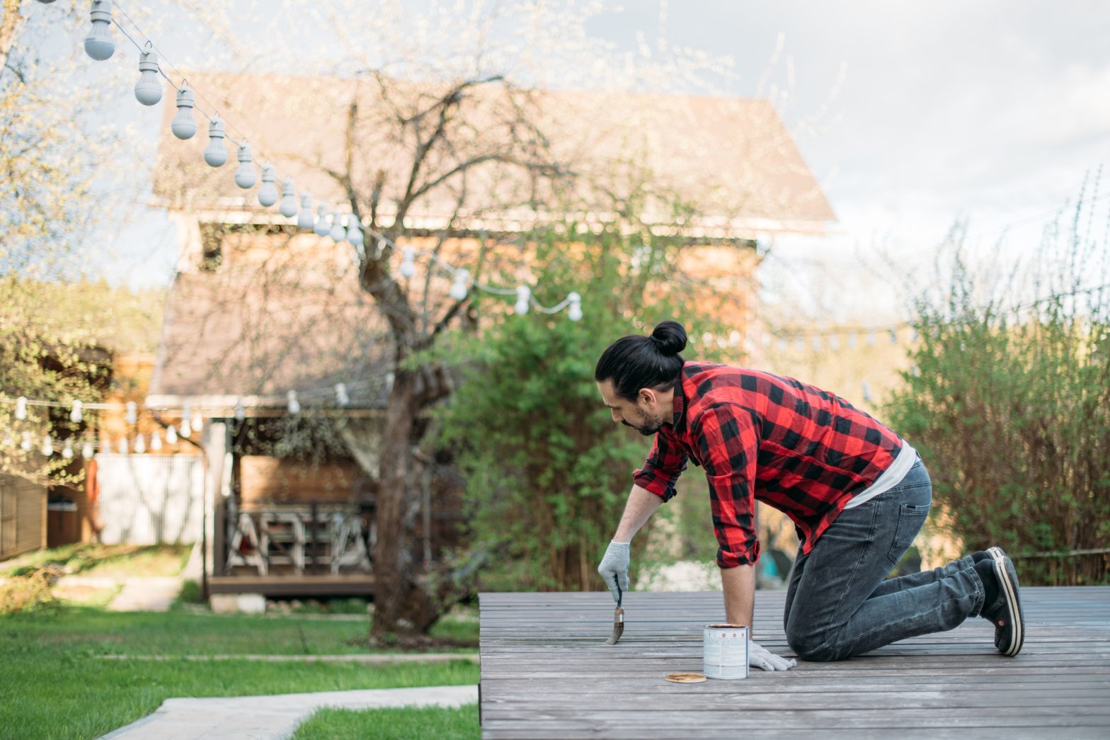 a young man repairing his deck
