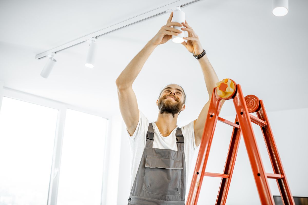 a man working on a light fixture