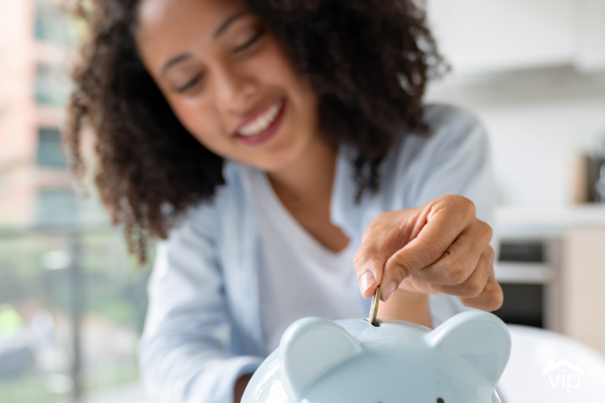 a woman putting a quarter in a piggy bank
